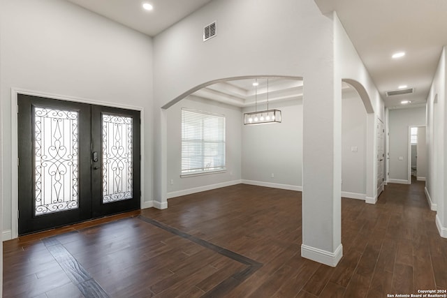 foyer entrance with french doors and dark hardwood / wood-style floors