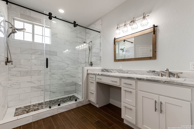 bathroom featuring walk in shower and vanity