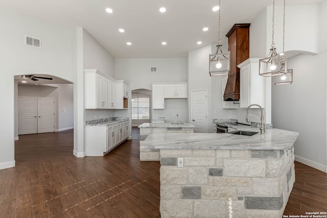 kitchen featuring ceiling fan, pendant lighting, white cabinets, sink, and dark hardwood / wood-style floors