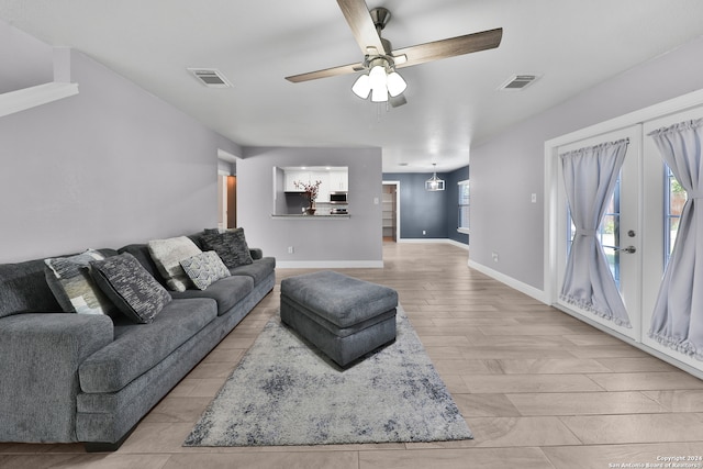 living room featuring light wood-type flooring and ceiling fan