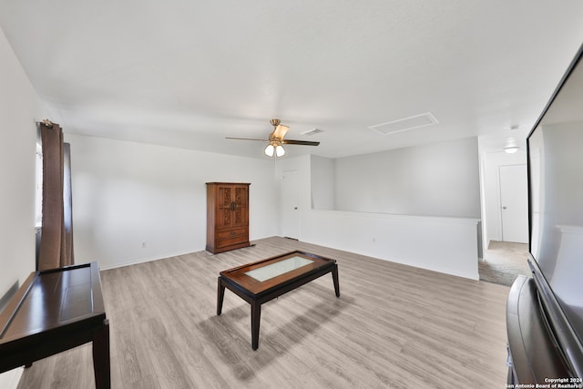 living room featuring light wood-type flooring and ceiling fan