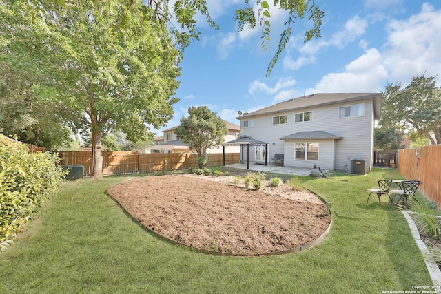 rear view of property featuring a gazebo, a yard, a patio area, and central AC