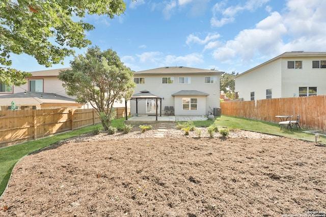 rear view of house featuring a gazebo and a patio