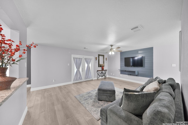 living room featuring ceiling fan and light wood-type flooring