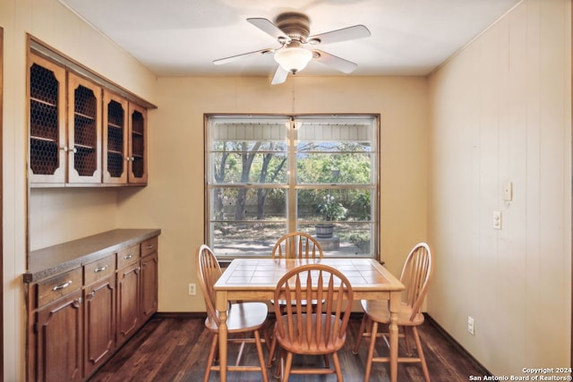 dining space featuring dark hardwood / wood-style flooring and ceiling fan