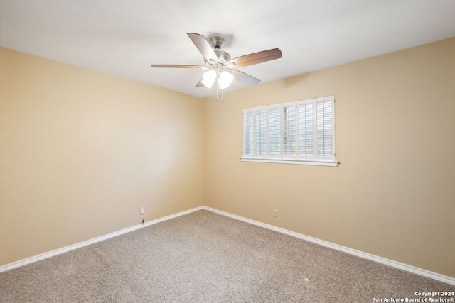 spare room featuring carpet floors and ceiling fan