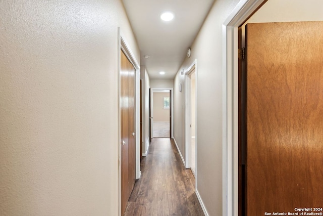 corridor featuring dark hardwood / wood-style floors