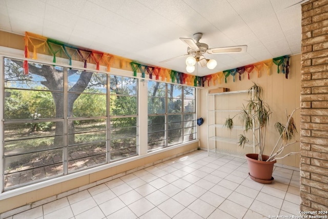 unfurnished sunroom featuring ceiling fan