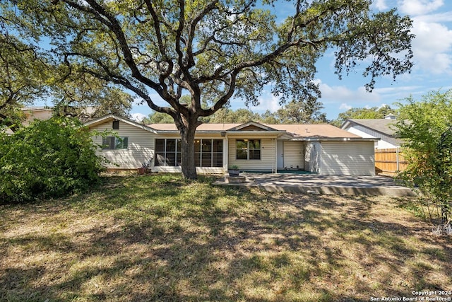 single story home with a front lawn and a patio