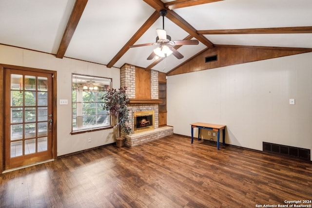 unfurnished living room with vaulted ceiling with beams, a fireplace, dark hardwood / wood-style floors, and ceiling fan