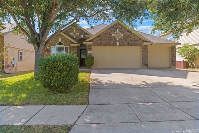 view of front facade with a front yard and a garage