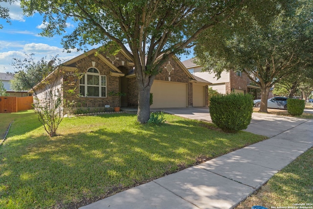 view of front of home featuring a garage and a front yard