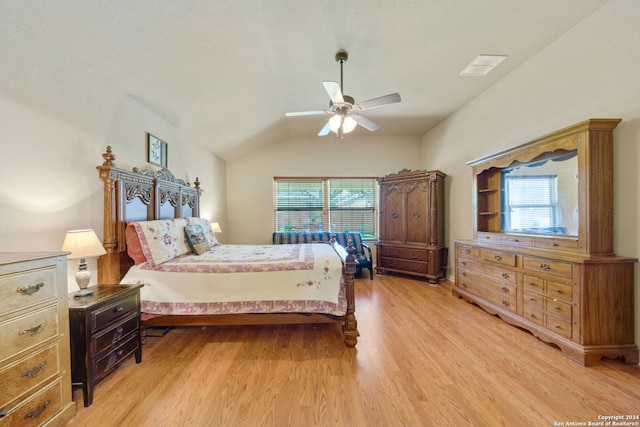 bedroom with light wood-type flooring, ceiling fan, and vaulted ceiling