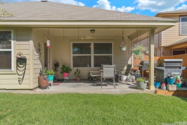 back of property featuring a yard and a patio