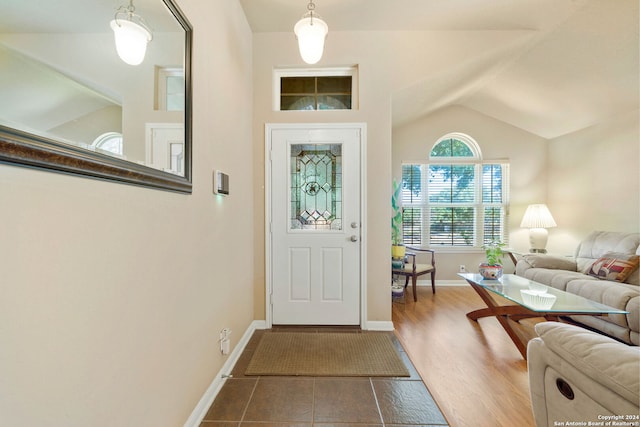 entrance foyer featuring hardwood / wood-style flooring and vaulted ceiling