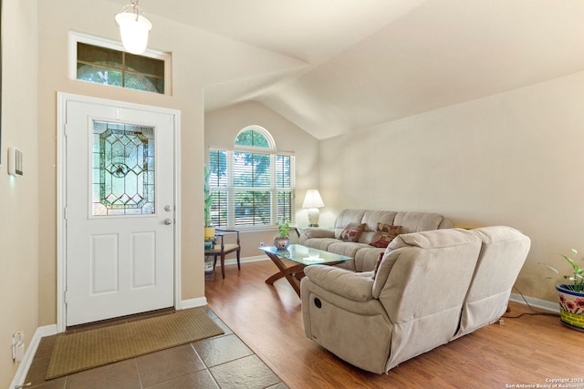 foyer with lofted ceiling and hardwood / wood-style floors