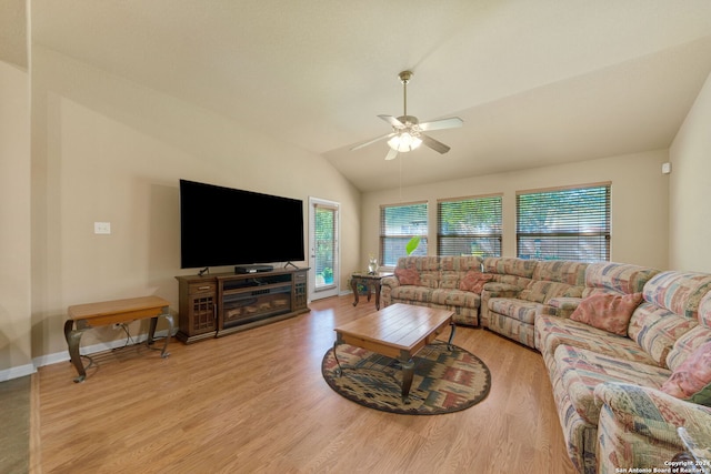 living room featuring ceiling fan, vaulted ceiling, and light hardwood / wood-style floors