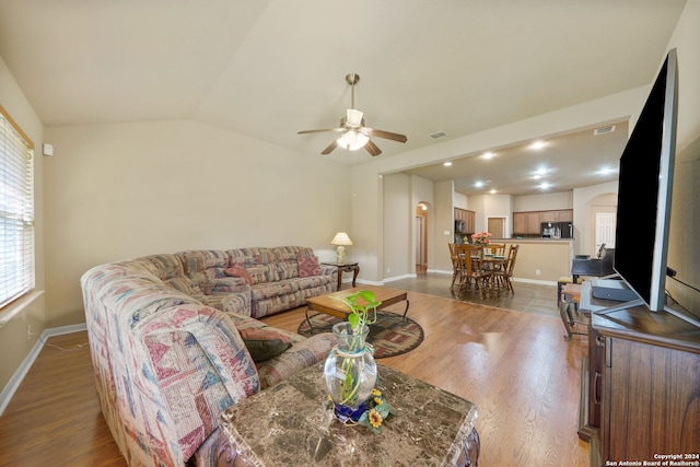 living room featuring lofted ceiling, hardwood / wood-style floors, and ceiling fan