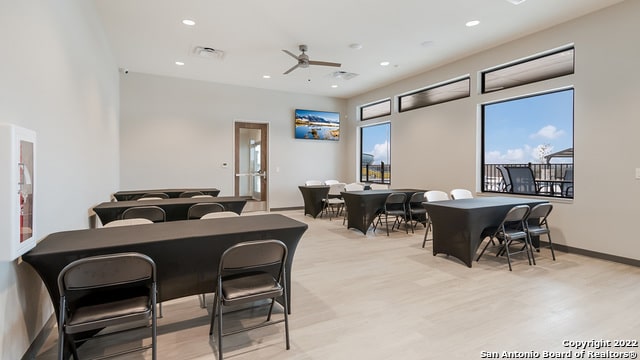 dining space with light wood-type flooring and ceiling fan