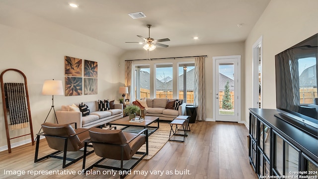 living room featuring ceiling fan, vaulted ceiling, and light hardwood / wood-style floors