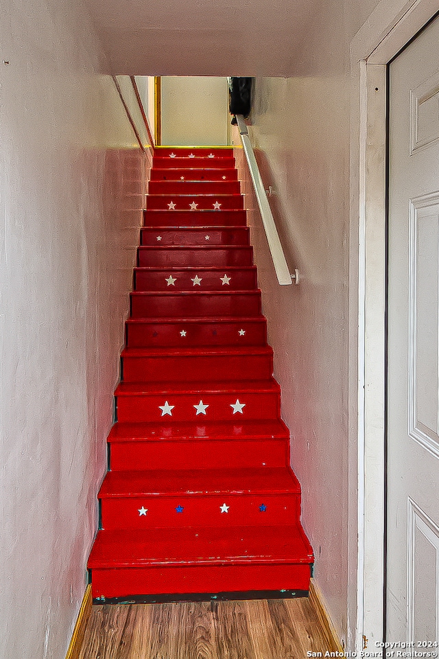 stairway with wood-type flooring