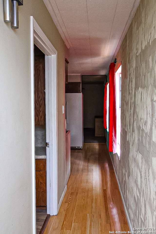 hall with hardwood / wood-style floors