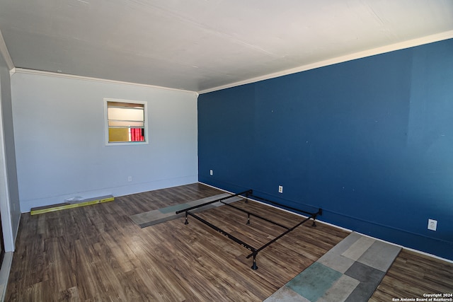 empty room featuring ornamental molding and hardwood / wood-style floors