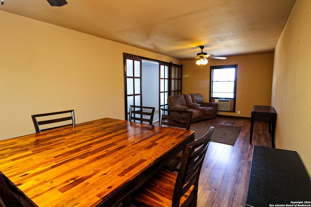 dining space featuring cooling unit, ceiling fan, and wood-type flooring