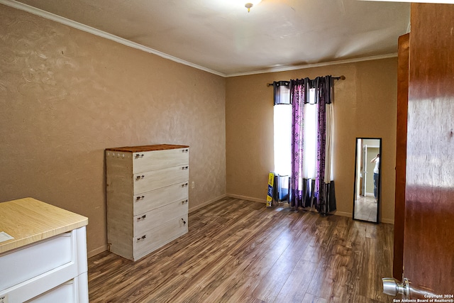 spare room with crown molding and dark hardwood / wood-style flooring