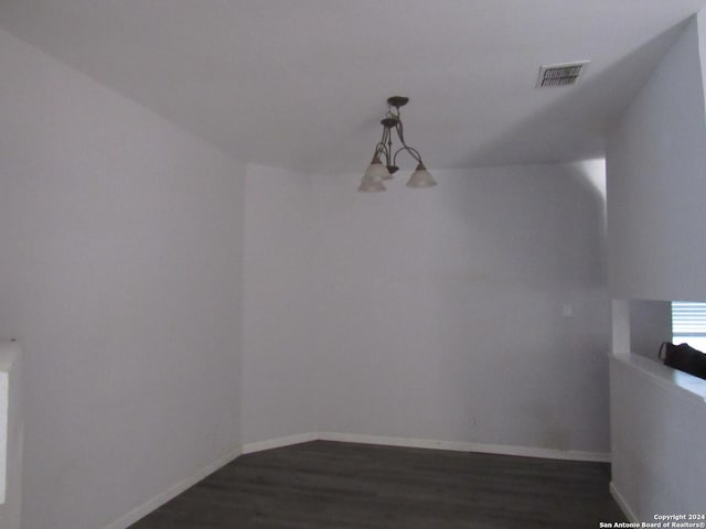 7731 Clear Ridge Dr, San Antonio, TX 78239 - unfurnished dining area with baseboards, dark wood-type flooring, visible vents, and an inviting chandelier