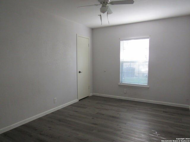 unfurnished room with dark hardwood / wood-style floors and ceiling fan