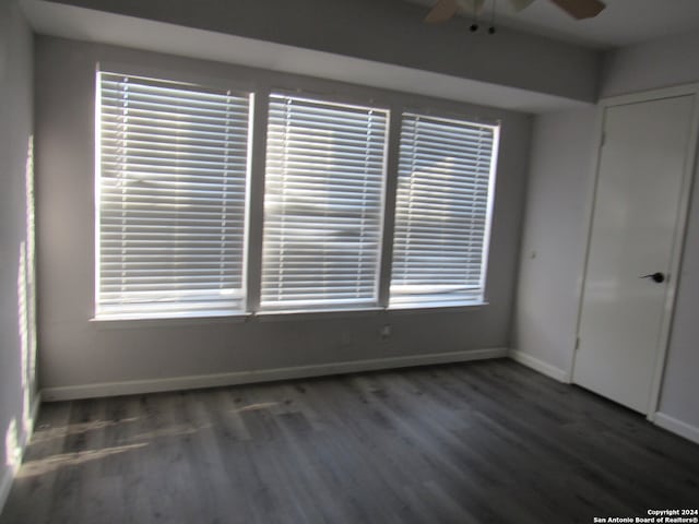 spare room with ceiling fan and dark hardwood / wood-style floors