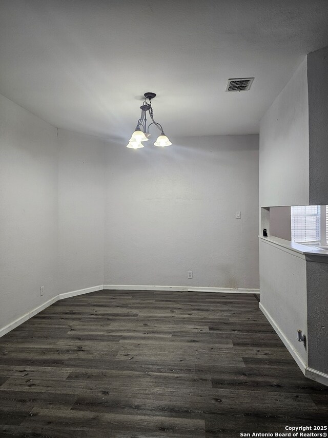 7731 Clear Ridge Dr, San Antonio, TX 78239 - unfurnished room featuring a chandelier, baseboards, visible vents, and dark wood-style floors