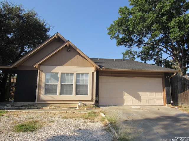 7731 Clear Ridge Dr, San Antonio, TX 78239 - view of front of property featuring a garage, concrete driveway, and fence