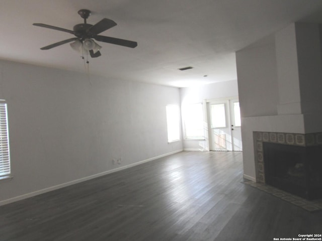 7731 Clear Ridge Dr, San Antonio, TX 78239 - unfurnished living room featuring a ceiling fan, a fireplace, dark wood finished floors, baseboards, and visible vents