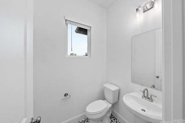 bathroom featuring sink, tile patterned flooring, and toilet