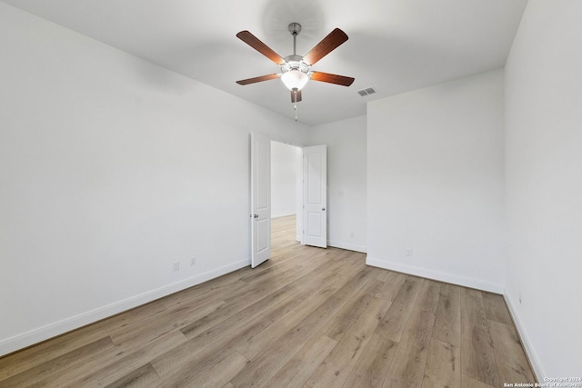 empty room featuring light hardwood / wood-style flooring and ceiling fan