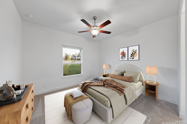 bedroom with ceiling fan and light colored carpet