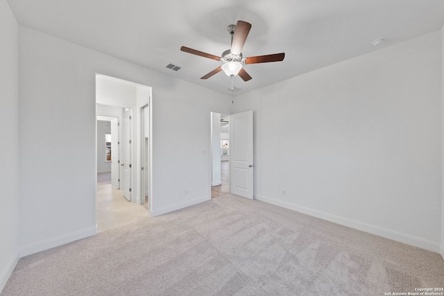 unfurnished bedroom featuring ceiling fan and light colored carpet