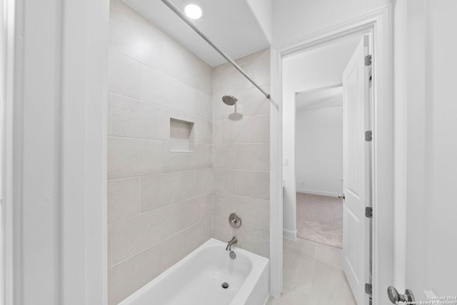 bathroom featuring tile patterned flooring and tiled shower / bath