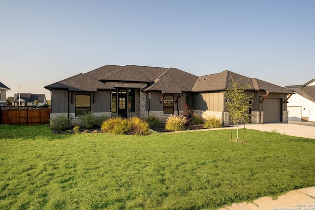 view of front of property with a garage and a front yard