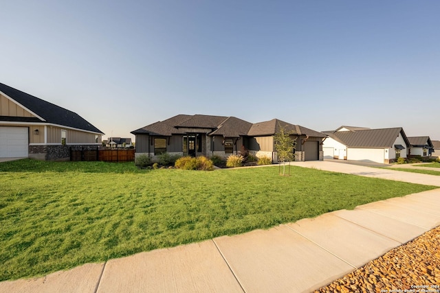 view of front of property featuring a garage and a front lawn