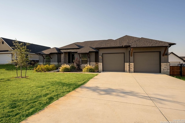 prairie-style house with a garage and a front lawn