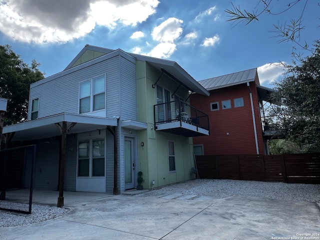 rear view of house featuring a balcony