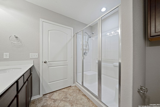 bathroom featuring an enclosed shower and vanity