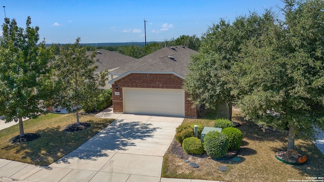 view of front of property featuring a garage and a front lawn