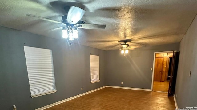 unfurnished room featuring ceiling fan, hardwood / wood-style floors, and a textured ceiling