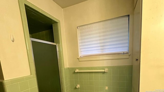 bathroom with tile walls