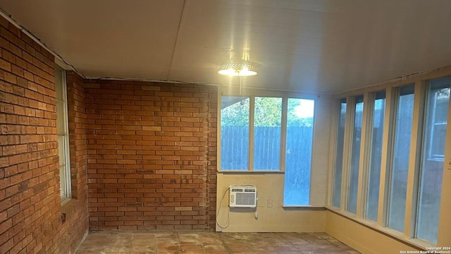 unfurnished sunroom with a wall mounted AC