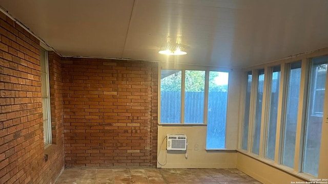 113 W Merriman St, Sinton, TX 78387 - unfurnished sunroom with brick wall and a wall unit AC